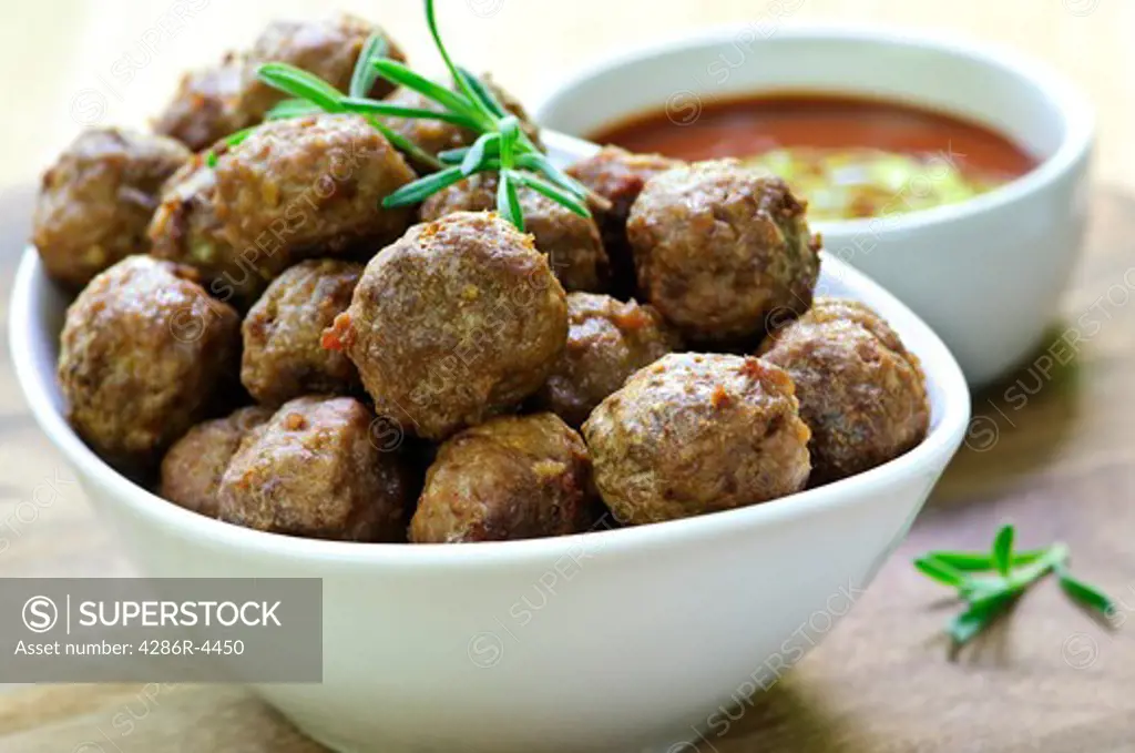 Fresh hot meatball appetizers served in white bowl with dipping sauce