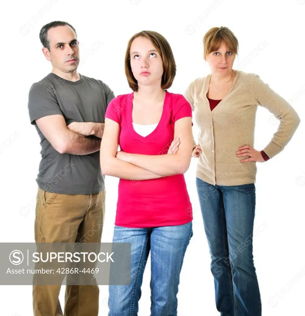 Teenage girl rolling her eyes in front of angry parents