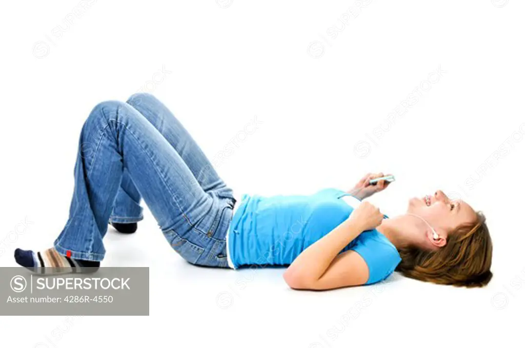 Teenage girl listening to music with her mp3 player
