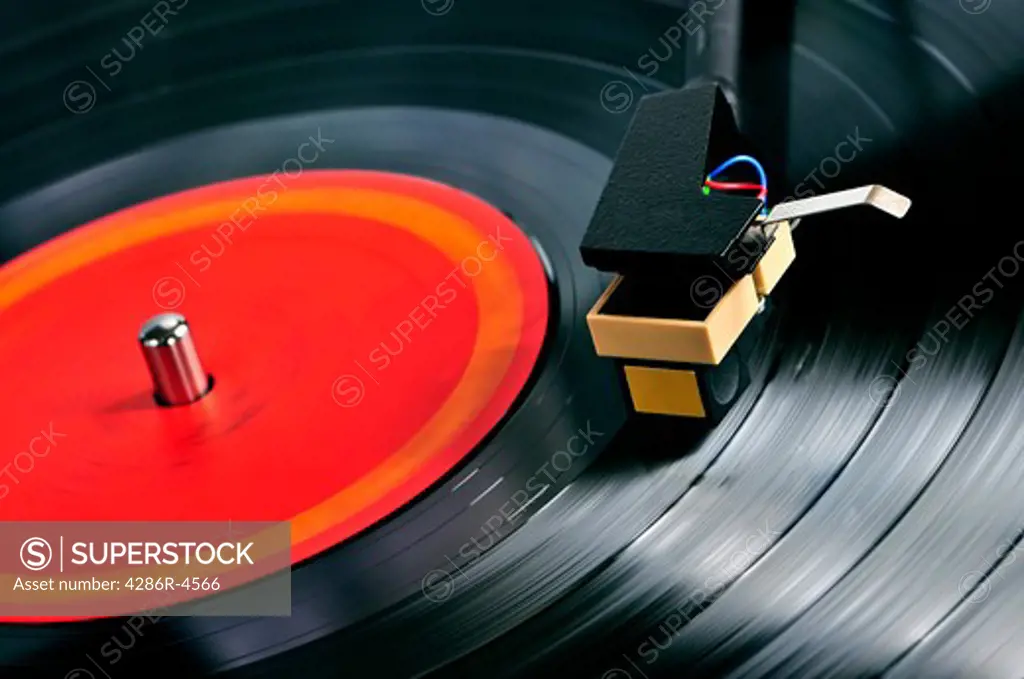 Vinyl record spinning on turntable close up - SuperStock