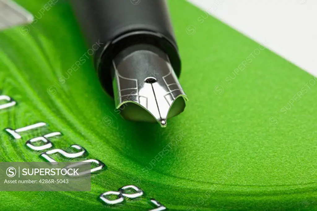 shopping - extreme closeup of a fountain pen and credit card