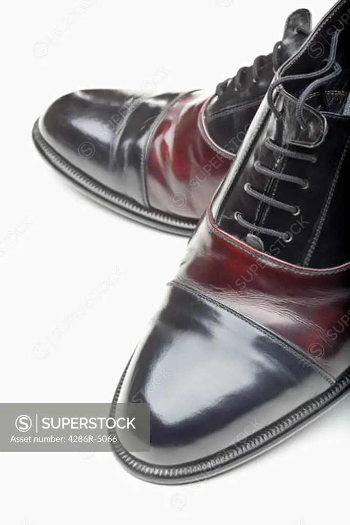 closeup of pair of shiny elegant men shoes isolated on white
