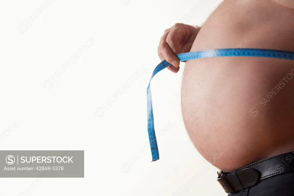 big belly of a fat man and measuring tape isolated on white