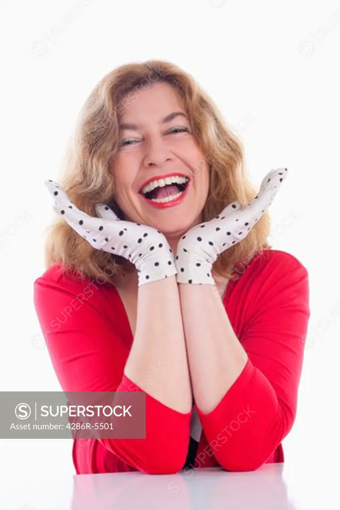 portrait of a middle-aged woman in red with polka-dot gloves - isolated on white