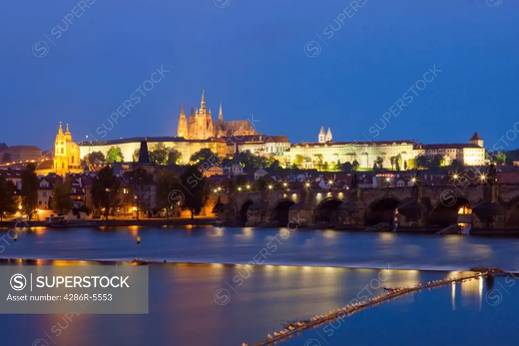 czech republic, prague - charles bridge and hradcany castle at dusk
