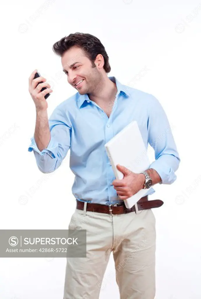 businessman with laptop looking at cellphone, smiling- isolated on white