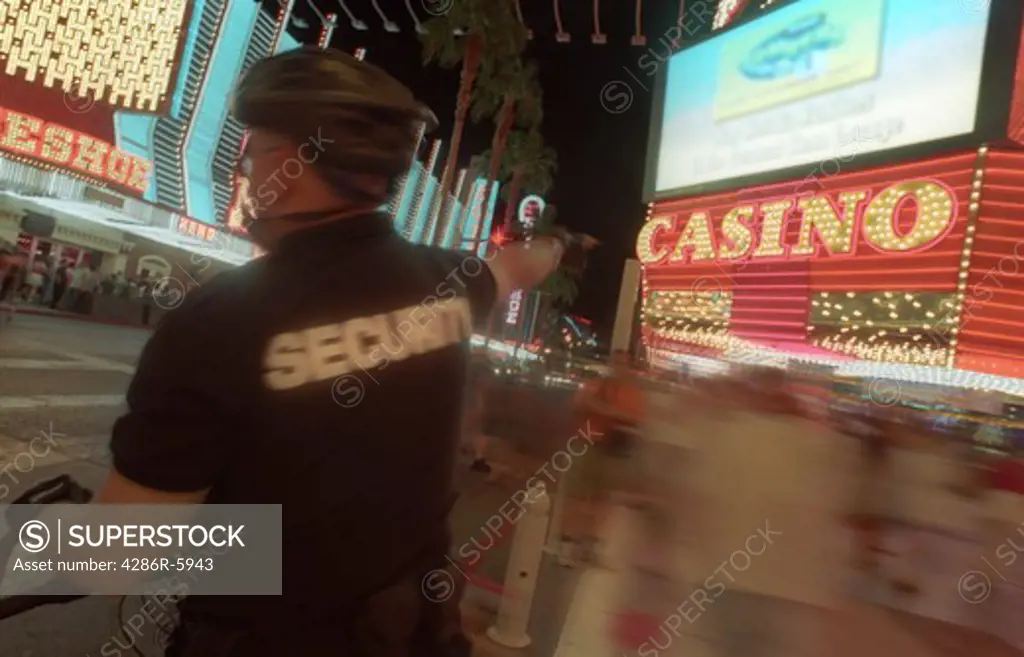 Security guard standing under light canopy at Fremont Street Experience in Old Town Las Vegas Nevada USA