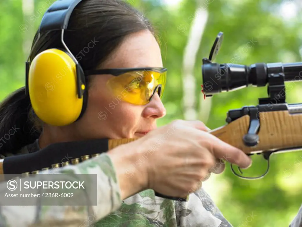 Close up of a caucasian woman firing a high power rifle