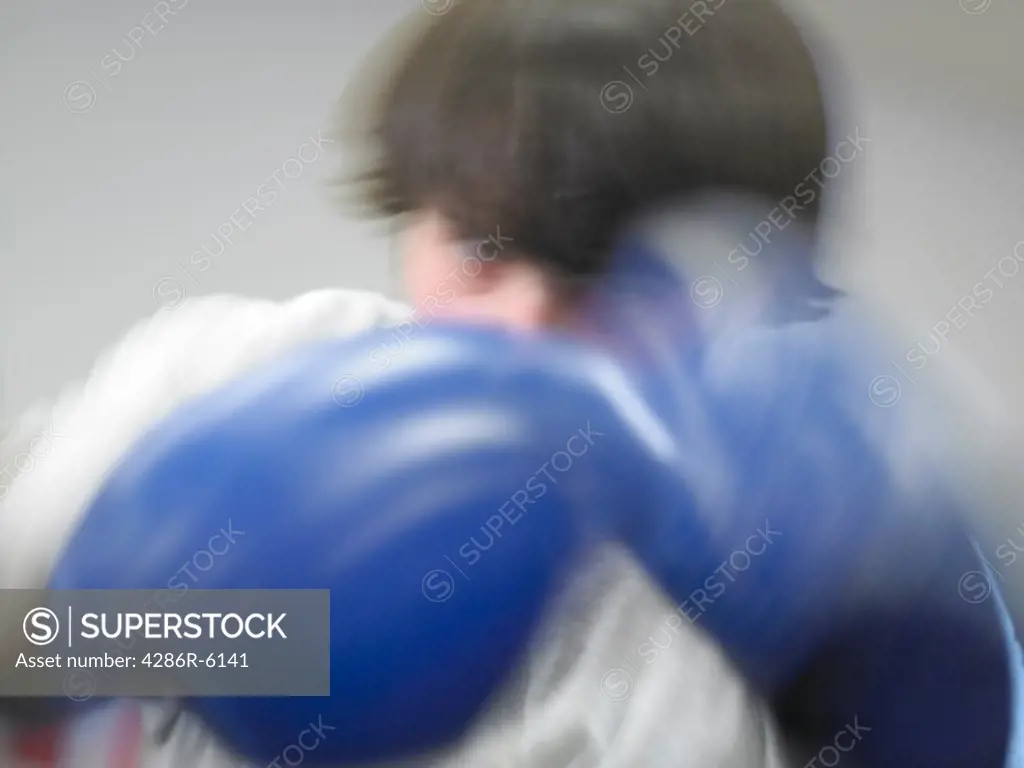 Blurred motion of caucasian male fists up in boxing stance