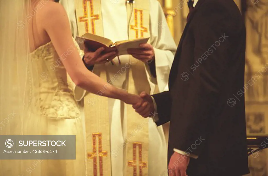 Bridal couple in church exchanging vows