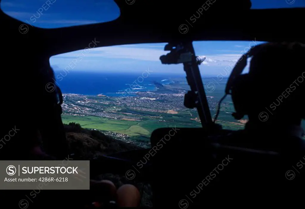 View from inside cockpit of a helicopter overlooking pinnaple fields in Maui Hawaii