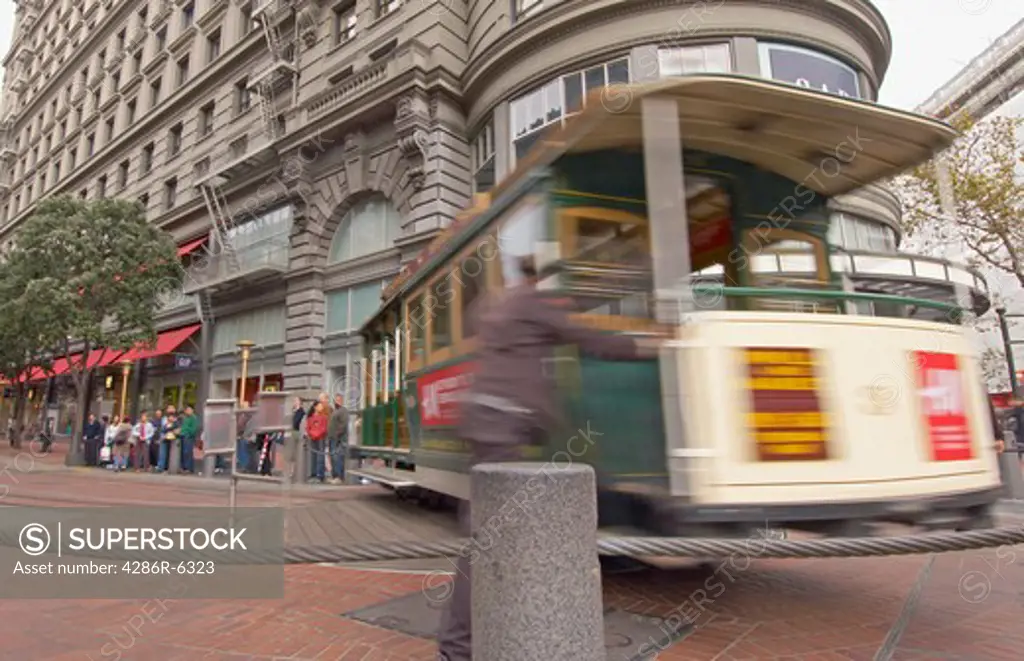 Famous cable car in San Francisco turned turned by manual lobor at the Powell St. turnaround.