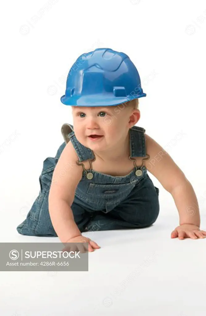 A toddler wearing a blue hard hat.