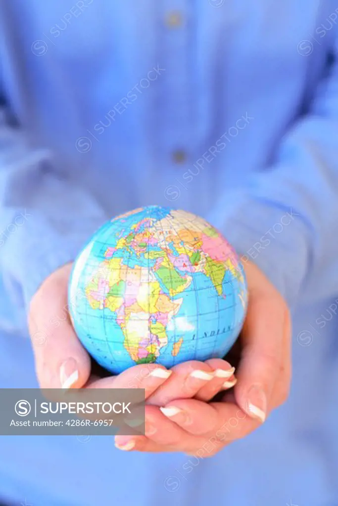 Hands holding globe