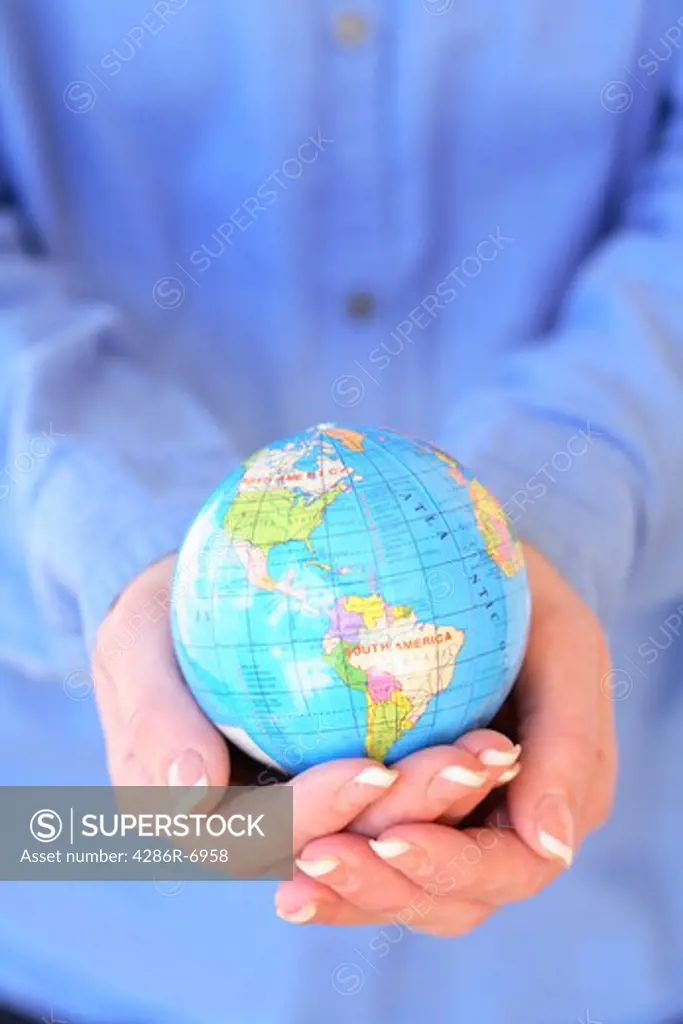 Hands holding globe