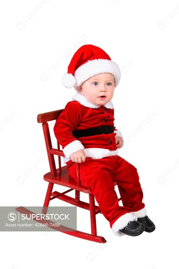 Baby in Santa suit on rocking chair