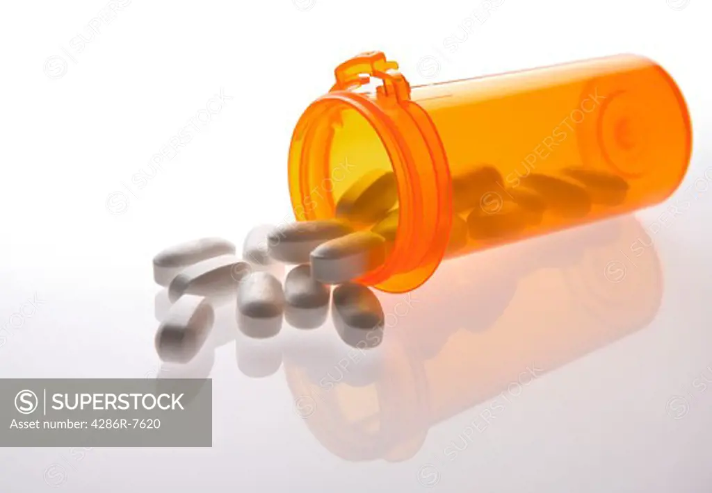 Pills spilling out of pill bottle