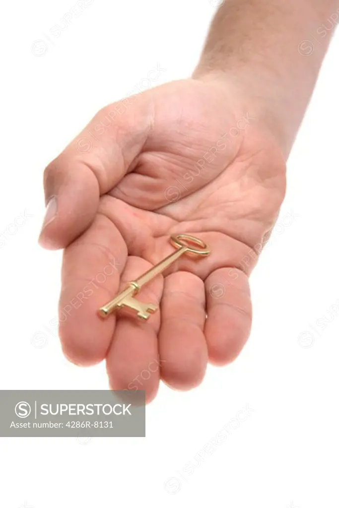 Hand holding gold key