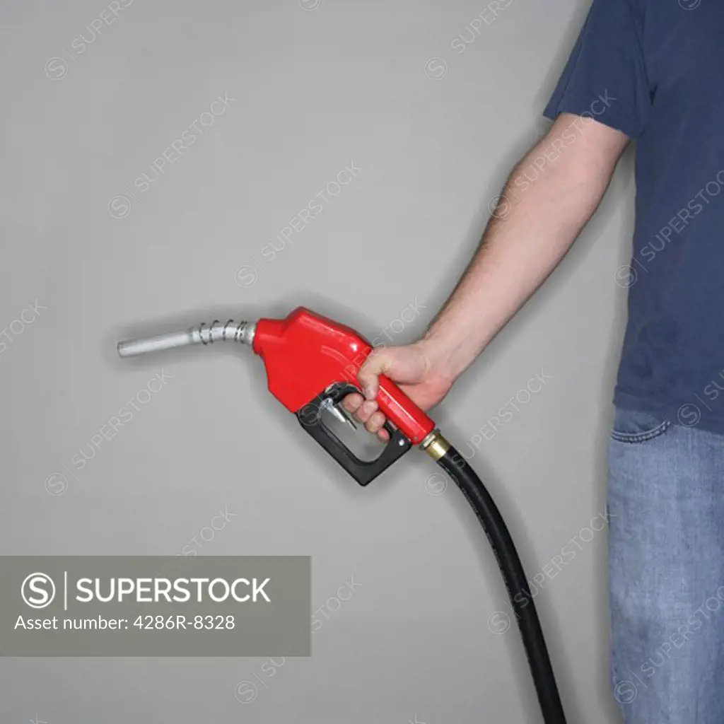 Man holding gas nozzle