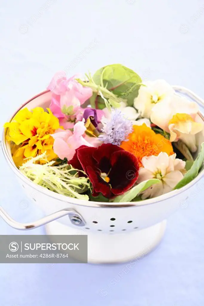 Colander full of edible flower salad