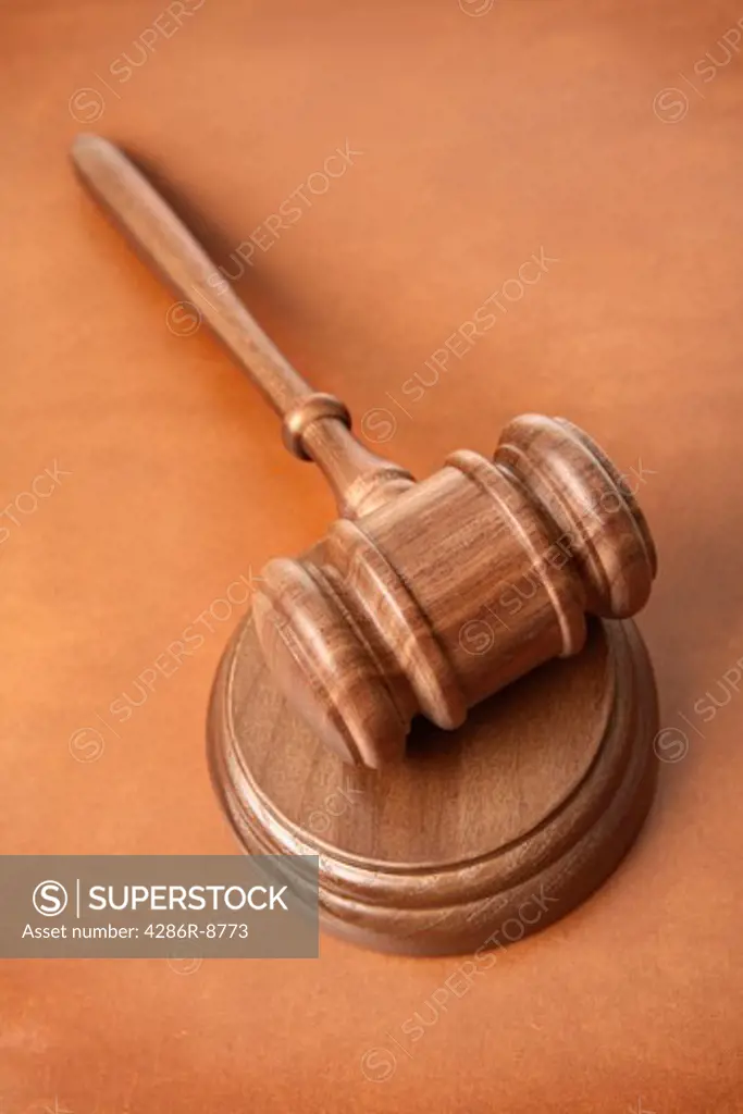 Gavel on brown leather surface