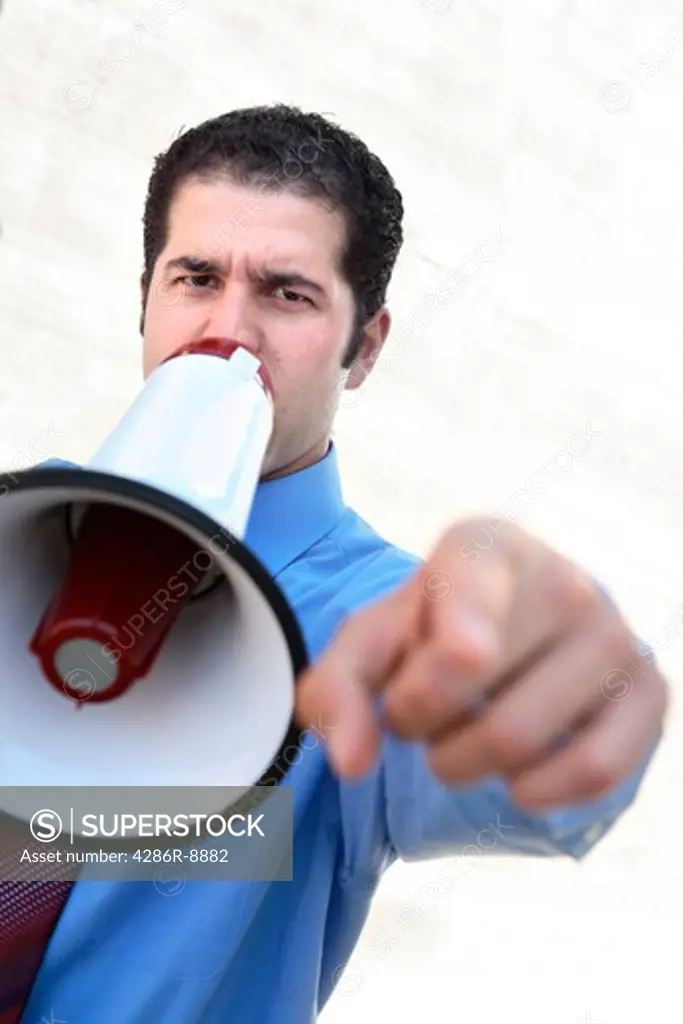 Businessman yelling into megaphone and pointing finger