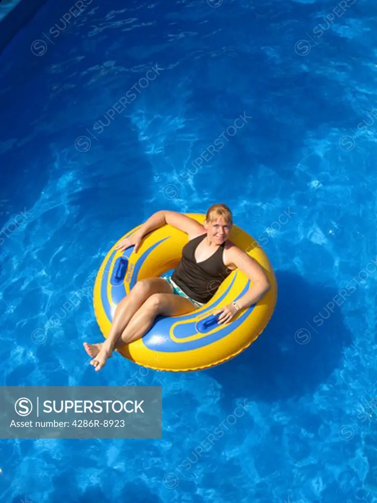 Woman floating in pool