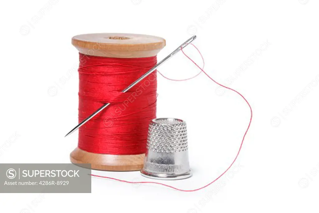 Spool of thread, needle and thimble