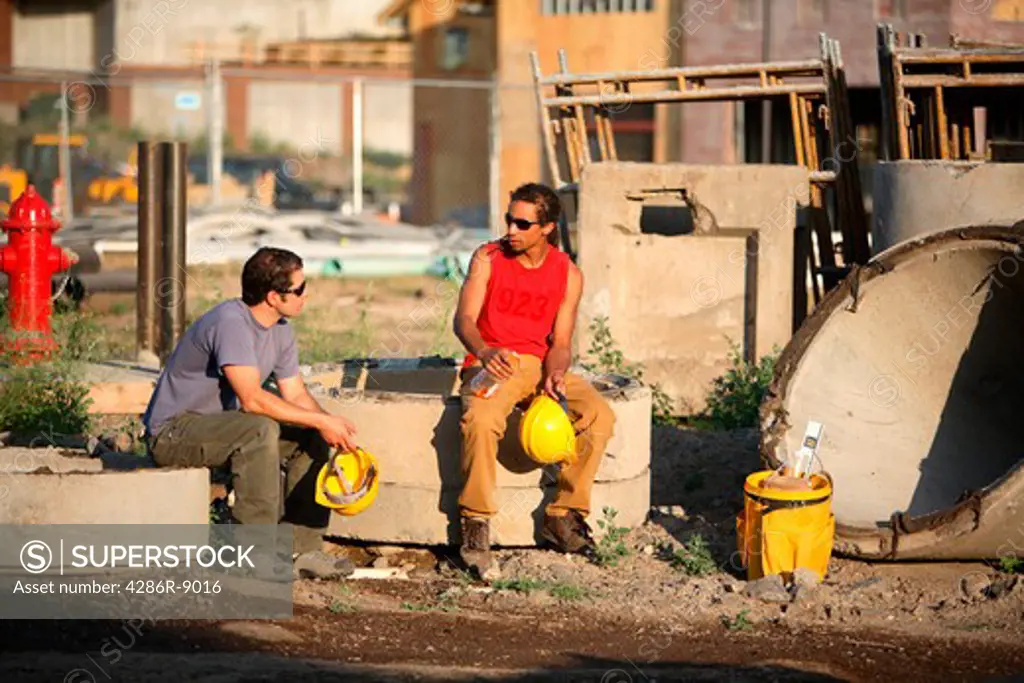 Construction workers sit down for a break