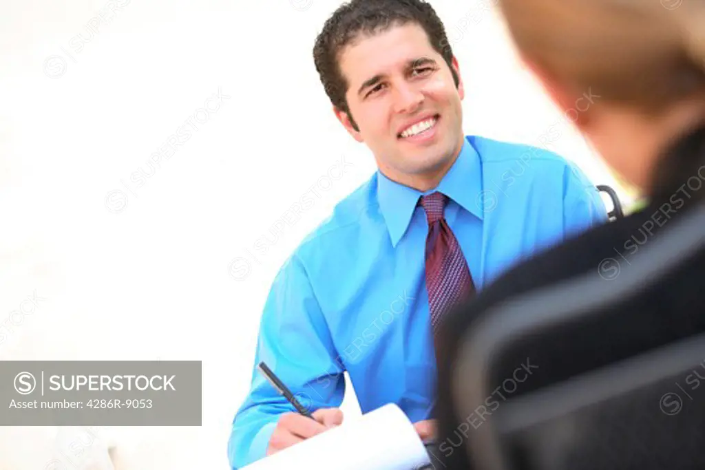 Young businessman interviewing woman