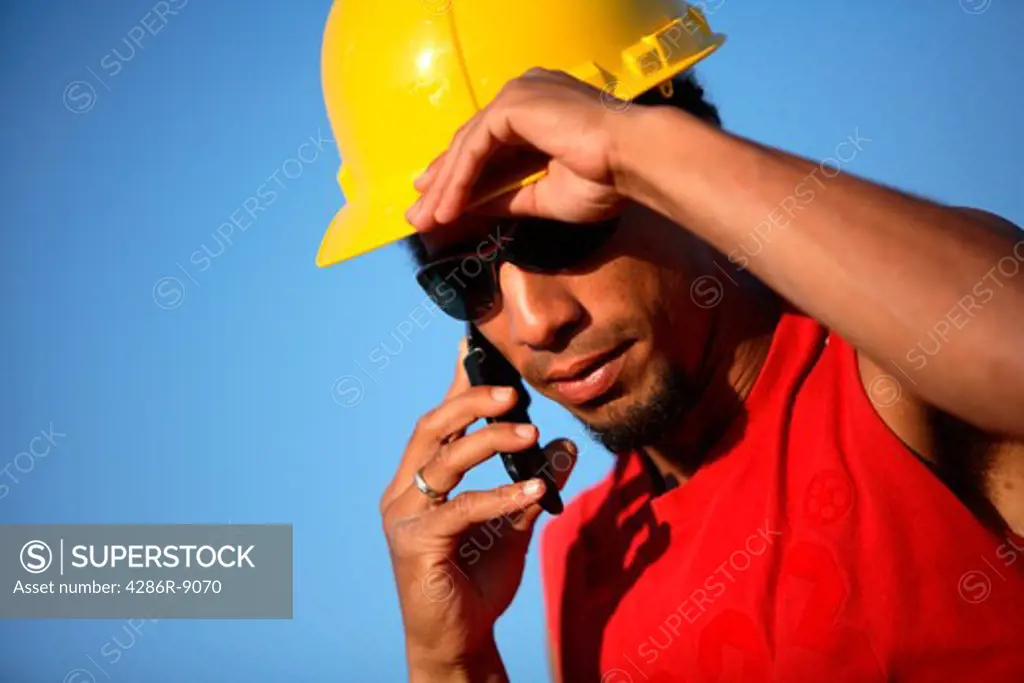 Construction worker talking on cell phone