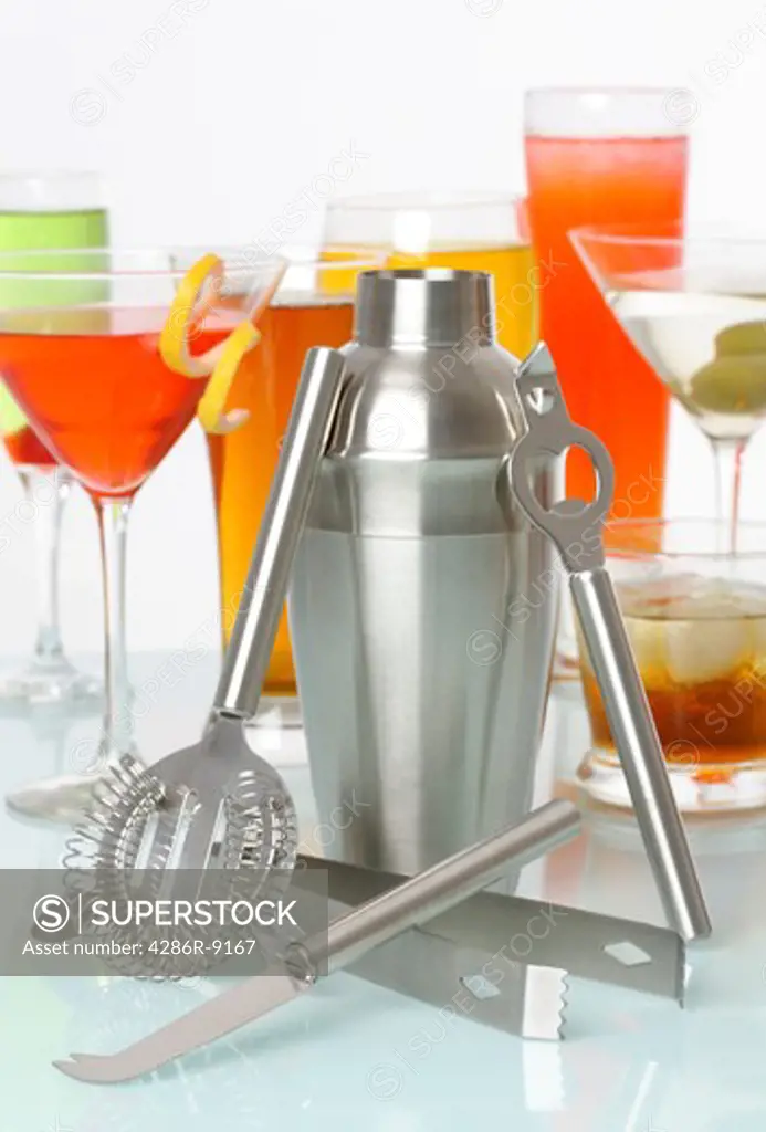 Bartending tools with a variety of drinks and cocktails  in background