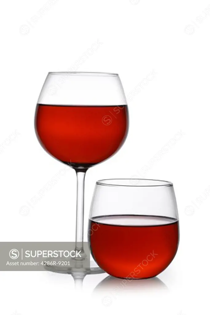 Red wine in traditional and stemless glasses cutout, isolated on white background