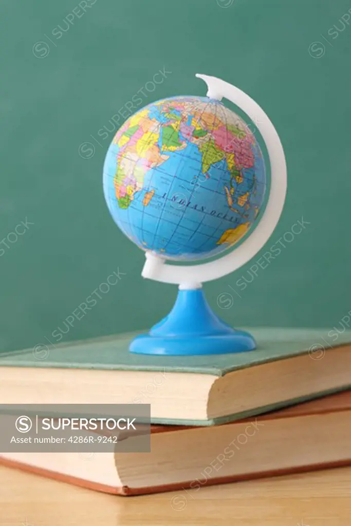 School education still life with globe on stack of books