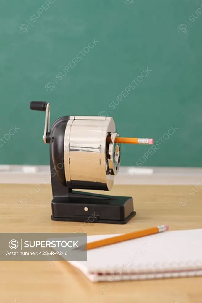 School education still life of a pencil sharpener and notepad