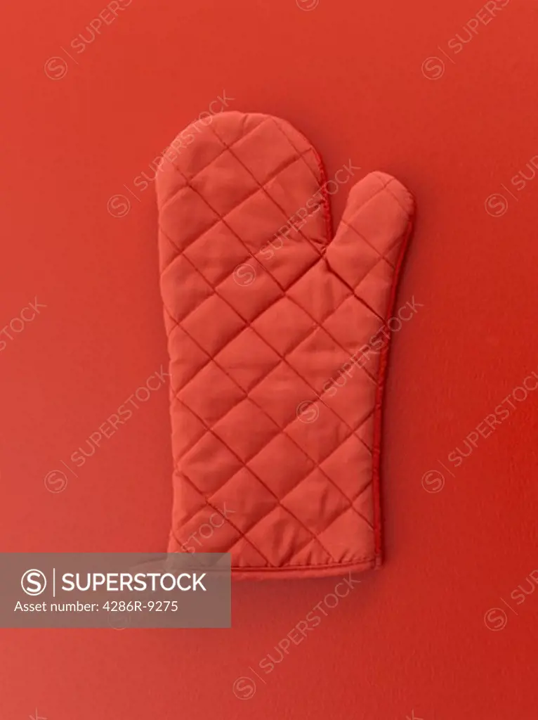 Red oven mitt on red background