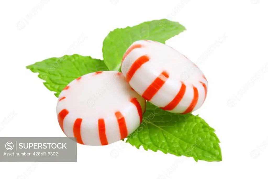 Peppermint candies and mint leaves cutout, isolated on white background