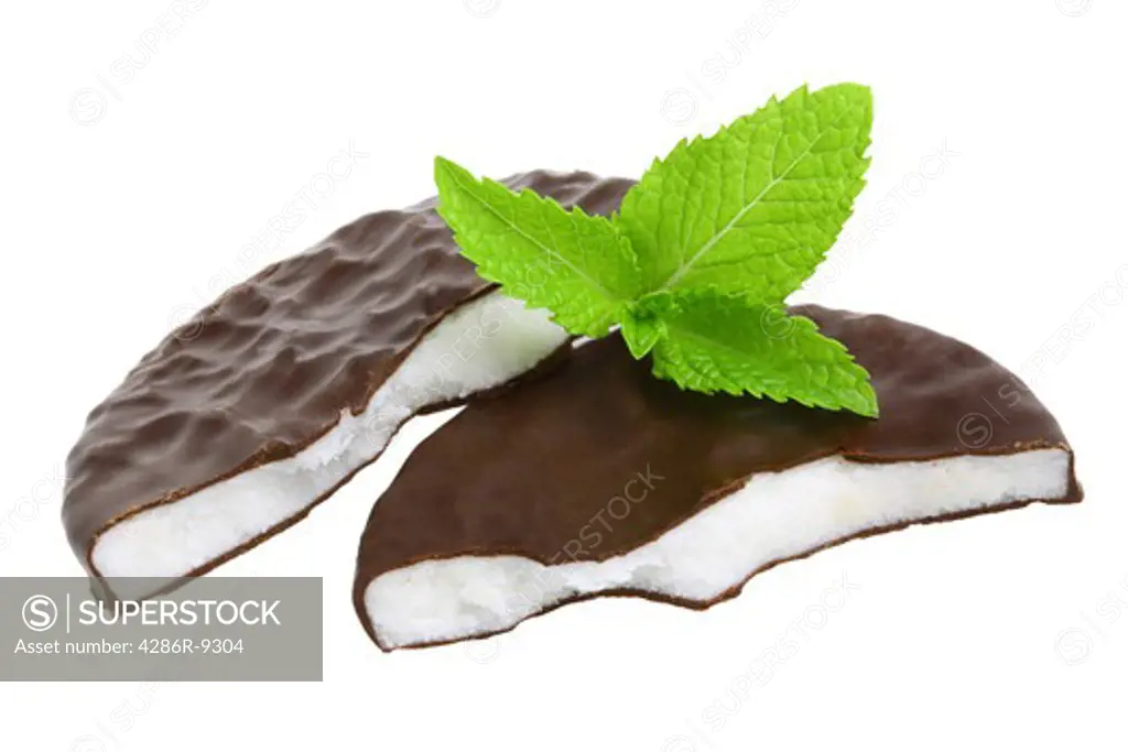 Peppermint patties and sprig of mint cutout, isolated on white background