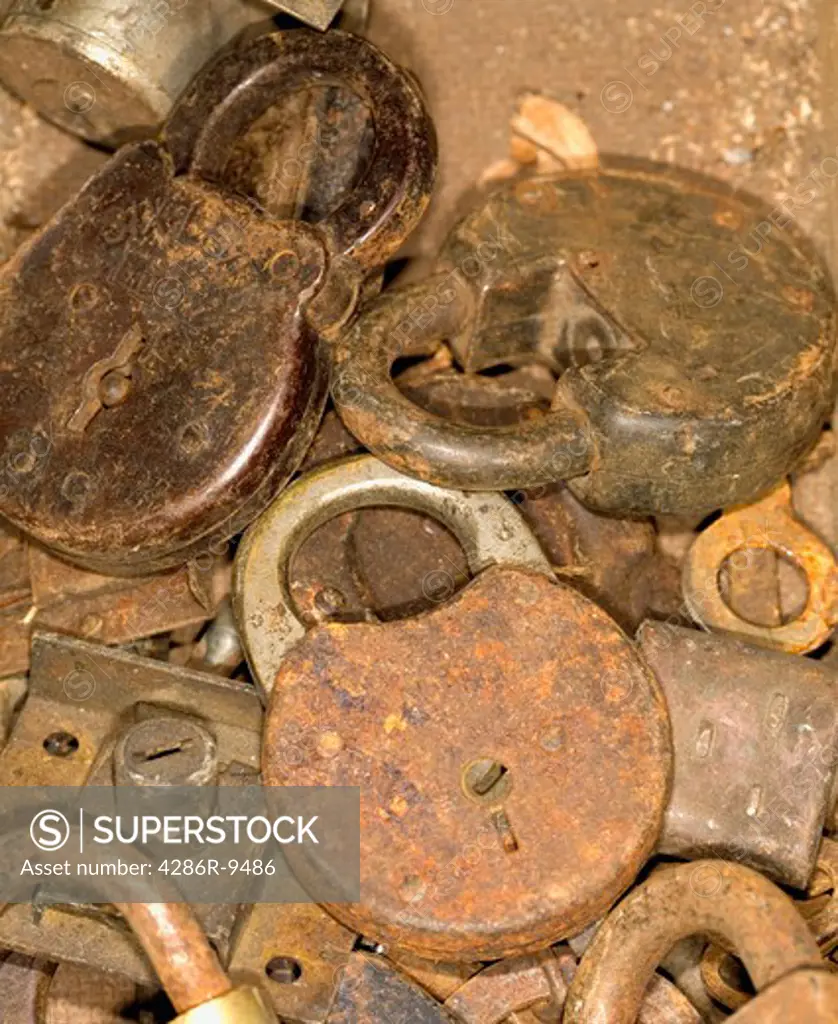 Still life of a pile of rusty locks.