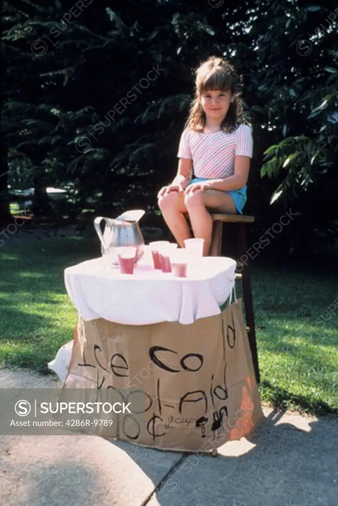 Young girl learning to be an entrepreneur selling cold drinks on  her  neighborhood block.