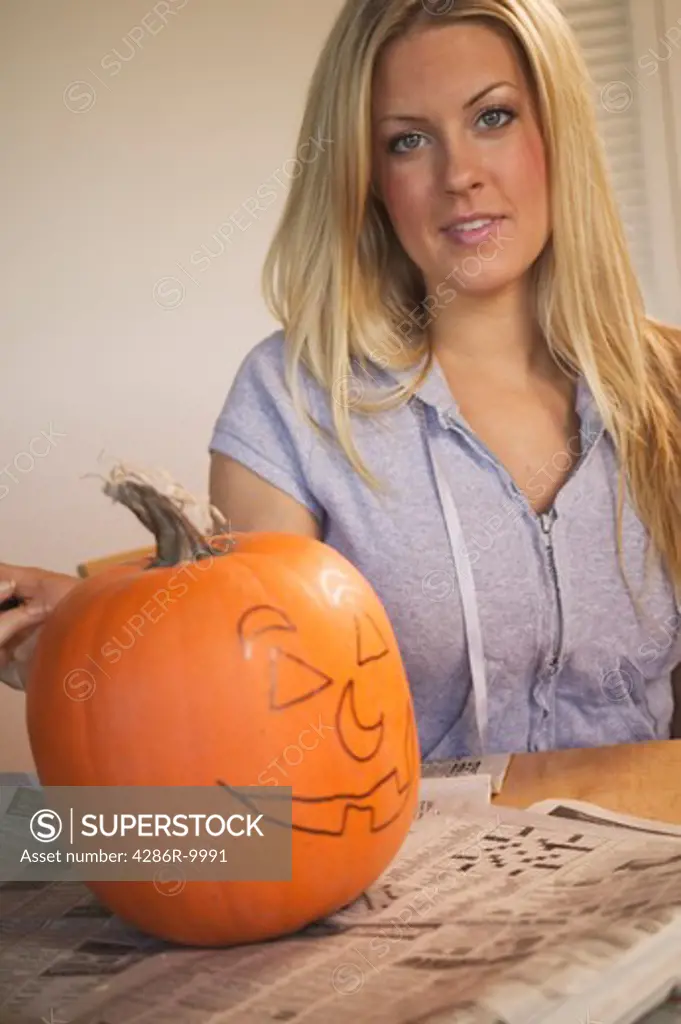 Young woman carving Halloween pumpkin  MR-0412  PR-0413