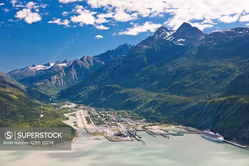 Aerial view of the city of Skagway with a cruise ship docked at port, Southeast Alaska, Summer