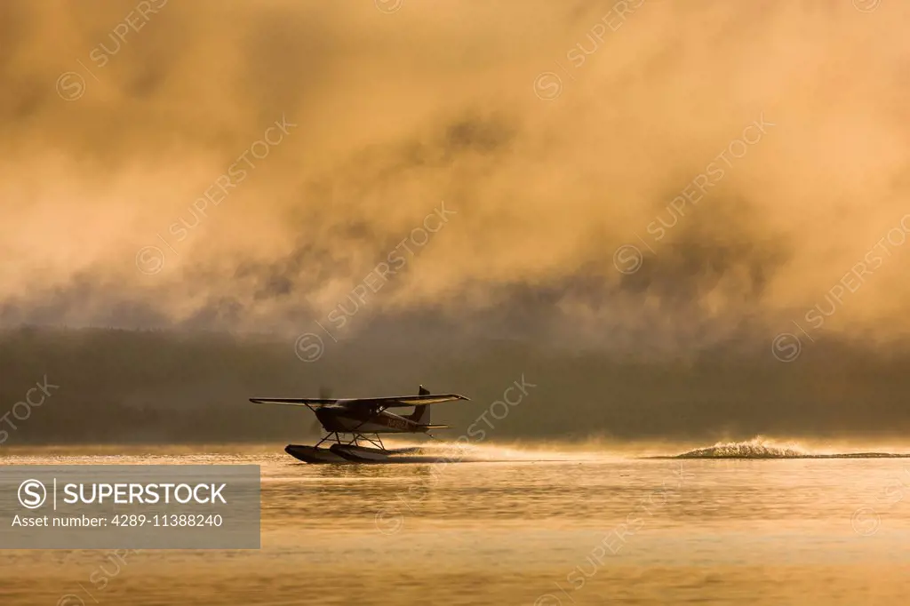 Float Plane Lands On Naknek Lake On A Foggy Morning, Katmai National Park, Alaska.