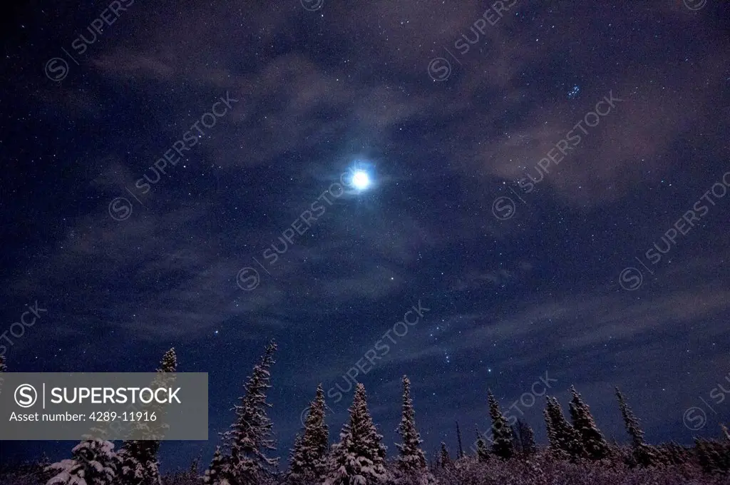 Full moon and a starry winter night over the hillside area above Anchorage, Southcentral Alaska, Winter