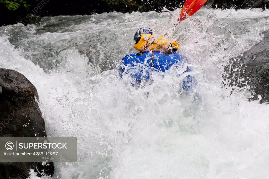 Man packrafting whitewater in lower Ship Creek near Anchorage, Southcentral Alaska, Summer