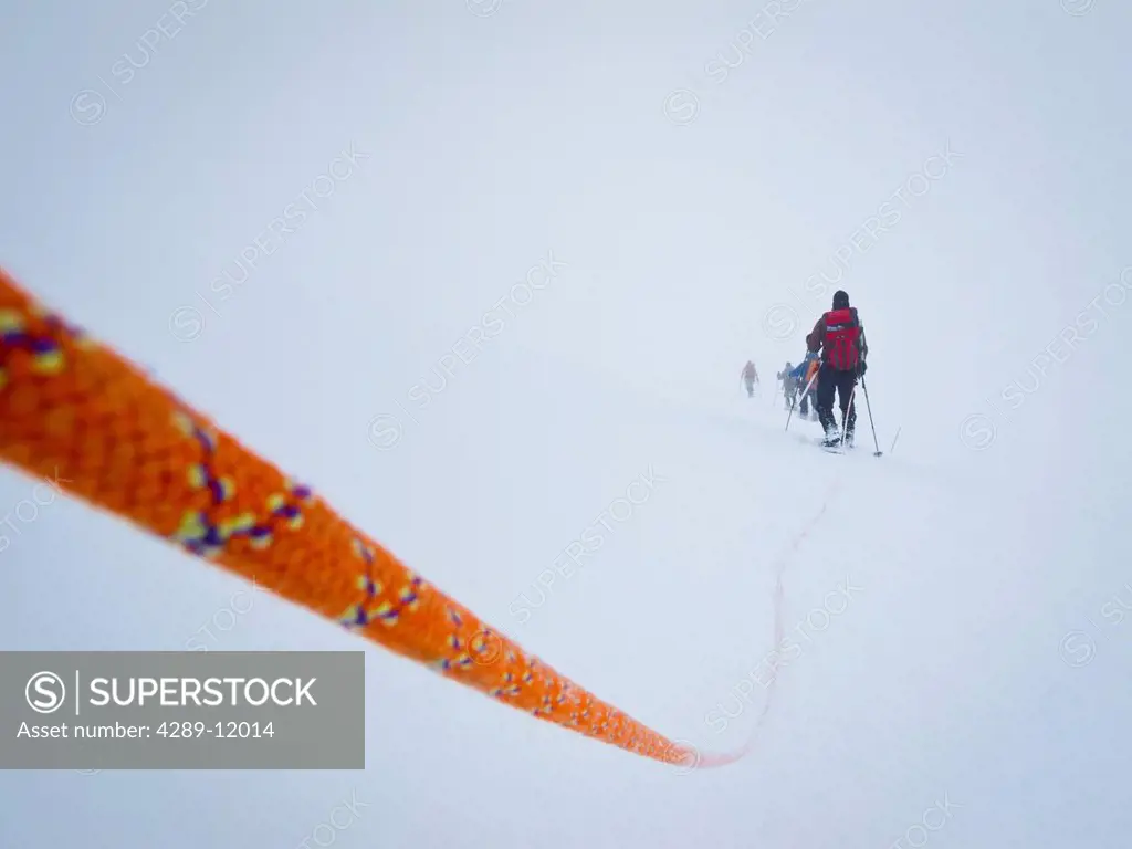 Rope team mountaineering in a whiteout on the Kahiltna Glacier, Mt. McKinley, Denali National Park & Preserve, Interior Alaska, Summer