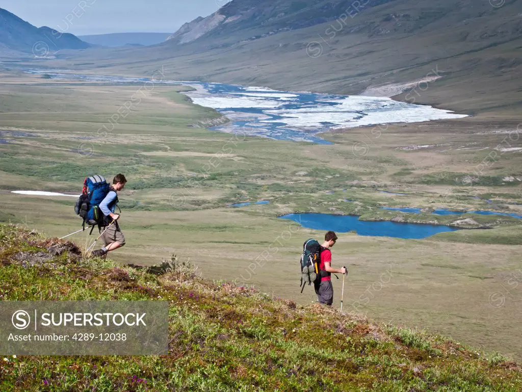 Backpackers hiking down to the Hulahula River, Arctic National Wildlife Refuge, Brooks Range, Summer in Arctic Alaska
