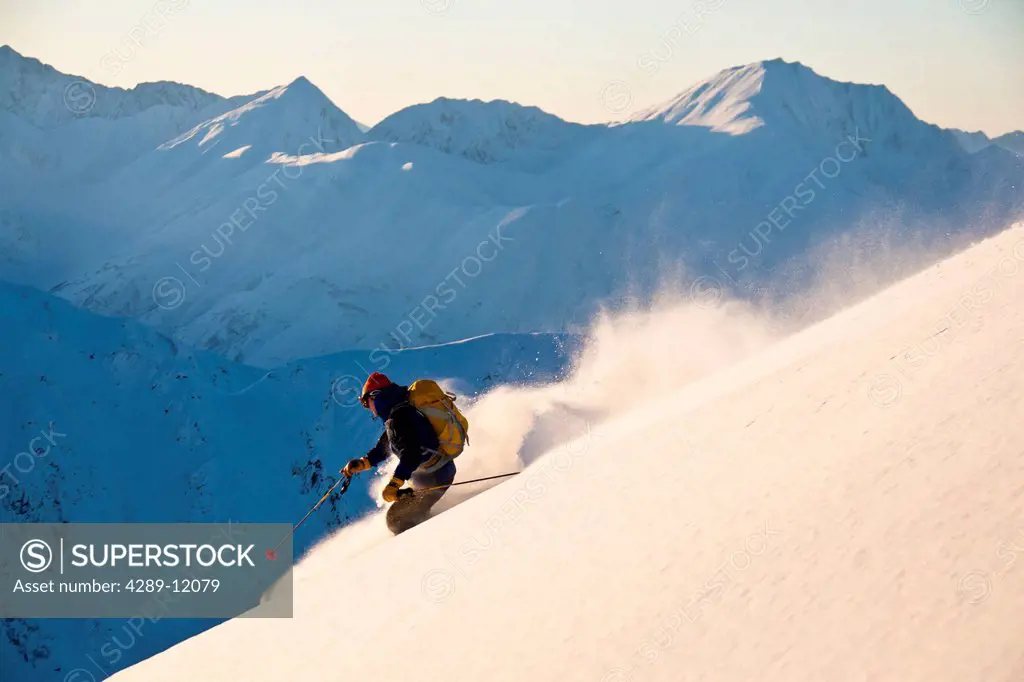 Man backcountry skiing powder on the south face of Cornbiscuit, Turnagain Pass, Kenai Mountains, Winter in Southcentral Alaska