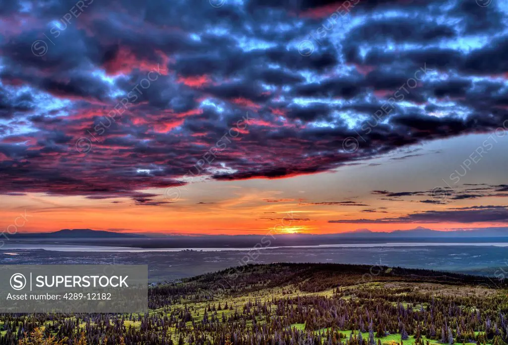 Colorful sunset over the Anchorage Bowl and Cook Inlet from the Chugach Mountains, Southcentral Alaska, Summer, HDR