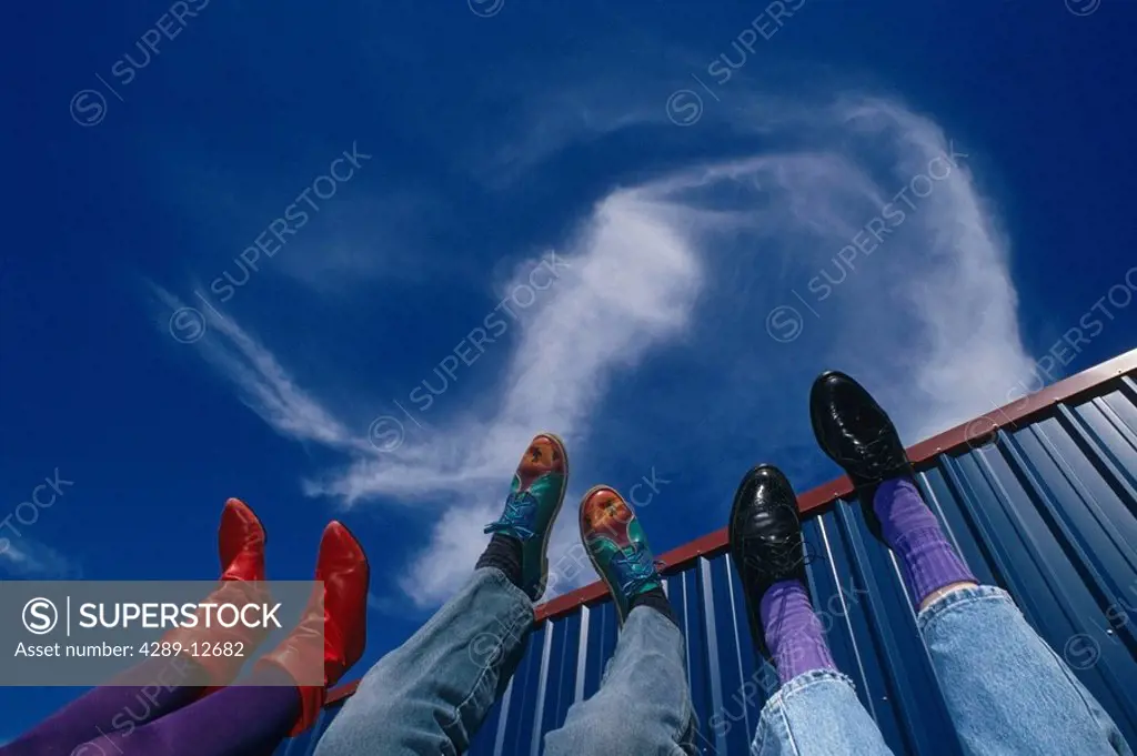 Still life of peoples feet point to blue sky USA Summer